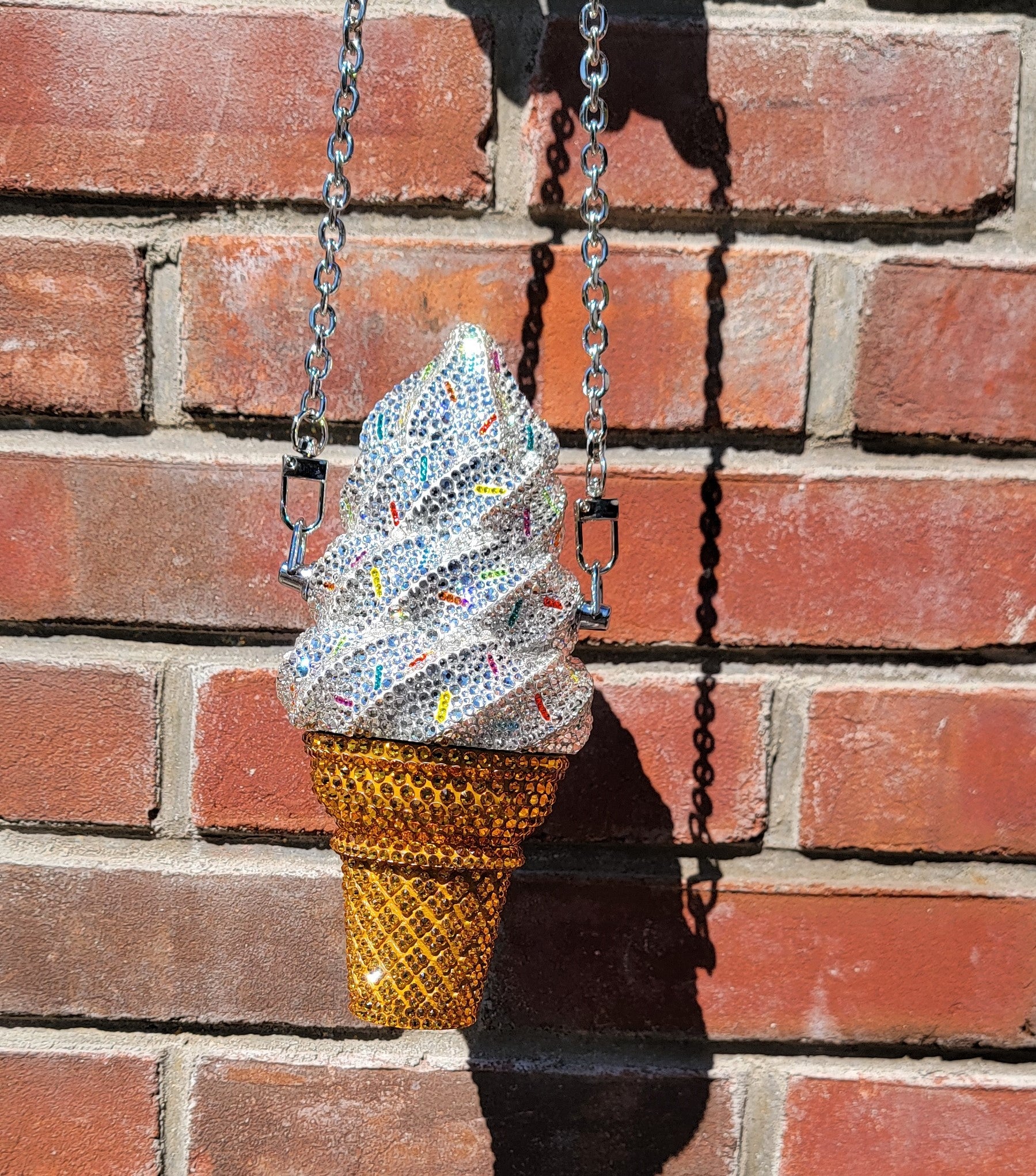 Soft Swerve Purse with Chain, Hanging against brick wall