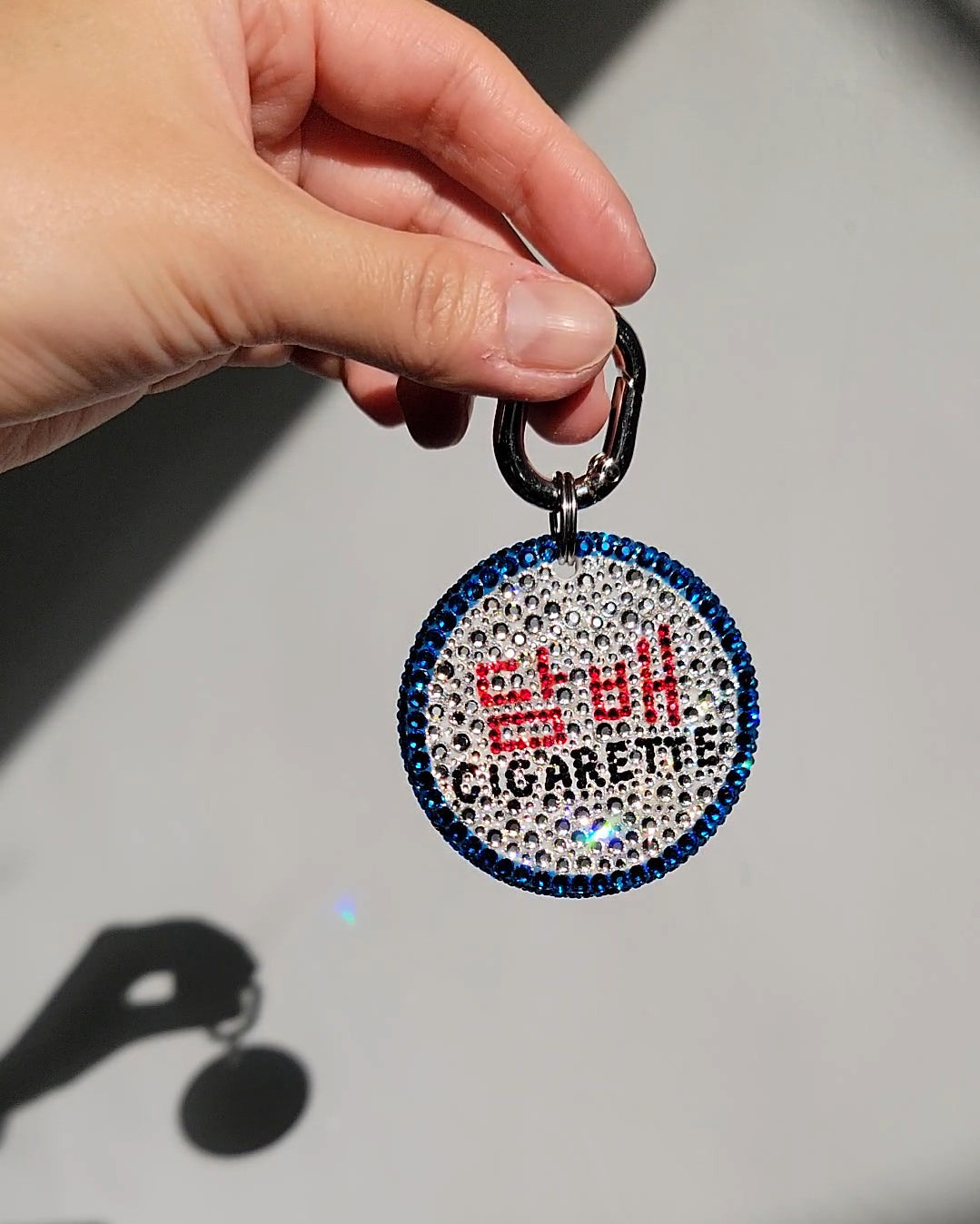 One side of the Nightlife Cigarette Sign Bag Charm, featuring prominent hangul